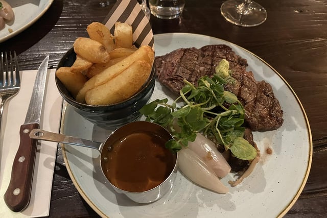 30 day-aged 10oz rib-eye steak, served with rustic thick-cut chips, beef dripping pangrattato shallots, exotic mushrooms, parsley butter and beef dripping sauce.
