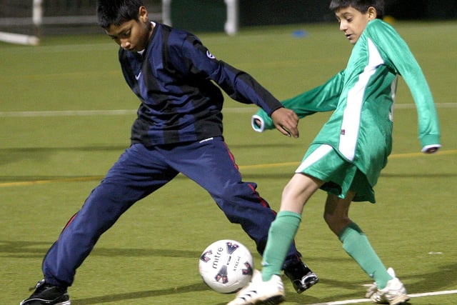 Football action from Simon De Senlis Primary School (green) v Castle Primary School (navy).