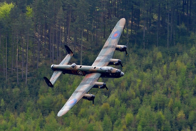 A Lancaster bomber flies over Derwent Reservoir in Derbyshire, England, as part of events marking the 70th Anniversary of an air-raid on three dams in Germany's Ruhr Valley  by a team of airmen dubbed the "Dambusters".   A British World War II Lancaster bomber performed a flypast Thursday over a reservoir used for practice runs by the legendary "Dambusters" airmen to mark 70 years since their daring raid over Nazi Germany's industrial heartland. The four-engined aircraft was joined by two Spitfires and two modern-day Tornado jets as they swept over the Derwent Reservoir in Derbyshire, northern England, where the Royal Air Force trialled the 'bouncing bomb'. AFP PHOTO/ANDREW YATES        (Photo credit should read ANDREW YATES/AFP via Getty Images)