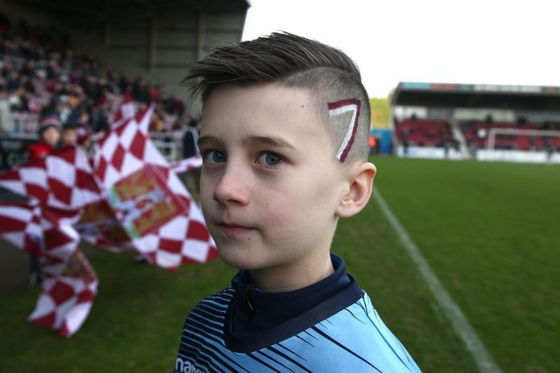A young Northampton Town fan with 7 painted on his hair as a tribute to Sam Hoskins who wears the No.7 shirt during the Sky Bet League Two match between Northampton Town and Cheltenham Town on December 29, 2019.