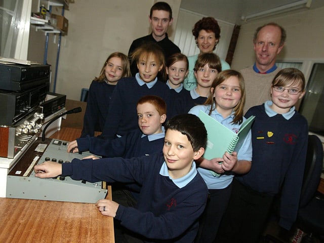 Pupils from Great Creaton Primary School visiting Northampton Association for the Blind, to record their poems in a recording studio. Pictured: Stephen Pascoe from Northampton Association for the Blind, Sue Edwards, co-ordinator of the BB trail at Brixworth Country Park and Richard Camp, headteacher, with pupils from Great Creaton Primary School. Pictured 2007