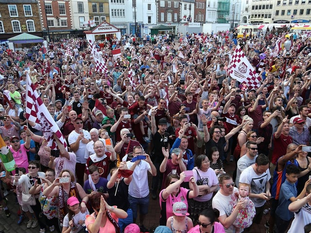 2016:  Northampton Town fans celebrate as they welcome the team as they enter the market sq during the Northampton Town Sky Bet League Two Winners Bus Parade on May 8, 2016 in Northampton, England.  (Photo by Pete Norton/Getty Images)