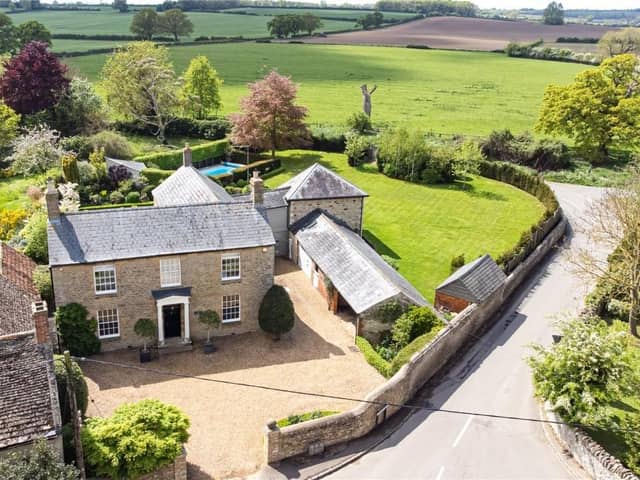 This traditional home has a modern twist, a huge swimming pool and rolling countryside views.