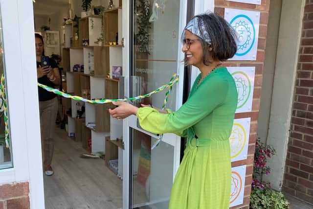 Business owner Mita opening the shop for the first time on launch day.