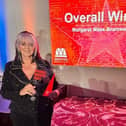 Margaret Whittaker collecting her award for Business Woman of the Year 2023