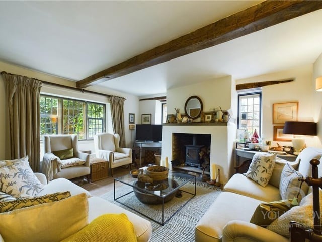 The wood-beamed lounge is charming and cosy with a fireplace mantle