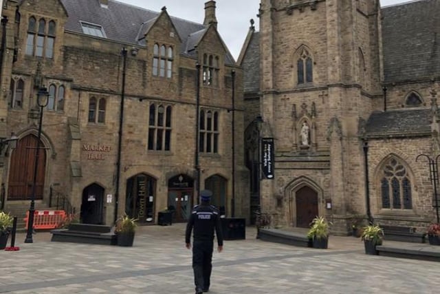 An officer in a deserted Durham Market Place