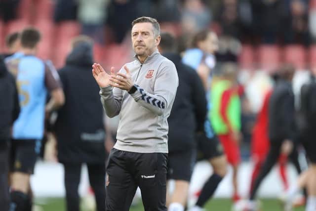 Jon Brady applauds the travelling fans after the full-time whistle.