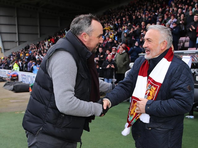 Northampton Town chairman Kelvin Thomas shakes the hand of former player and manager Phil Chard after being introduced as part of the 125th anniversary celebrations at half time during the Sky Bet League Two match between Northampton Town and Tranmere Rovers at Sixfields on March 05, 2022 in Northampton, England. (Photo by Pete Norton/Getty Images)