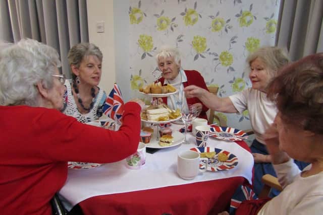 Residents at St. Christopher's Care Home enjoy their Coronation Day Afternoon Tea