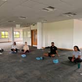 The Bhangals Construction Consultants team take part in a yoga session.