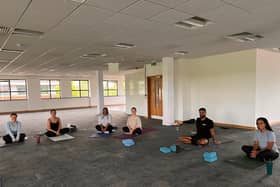 The Bhangals Construction Consultants team take part in a yoga session.