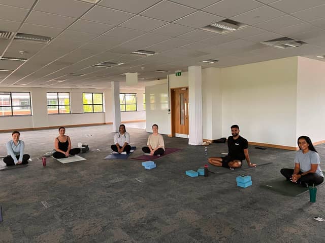 The Bhangals Construction Consultants team take part in a yoga session.