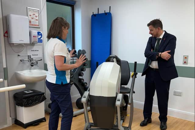 Mike Reader MP being shown physiotherapy equipment at Three Shires Hospital.