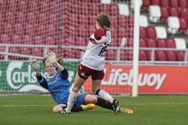 Beth Artemiou  lifts the ball over goalkeeper Lana Timson to score Northampton's second goal.