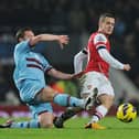 West Ham captain makes a challenge on Arsenal's Jack Wilshere during a Premier League game in 2013. (Photo by Stuart MacFarlane/Arsenal FC via Getty Images)