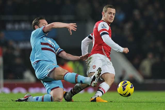 West Ham captain makes a challenge on Arsenal's Jack Wilshere during a Premier League game in 2013. (Photo by Stuart MacFarlane/Arsenal FC via Getty Images)