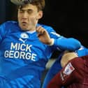 Cobblers striker Kieron Bowie battles for the ball at Peterborough on Tuesday (Picture: Pete Norton)