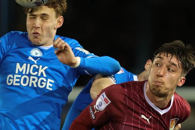 Cobblers striker Kieron Bowie battles for the ball at Peterborough on Tuesday (Picture: Pete Norton)