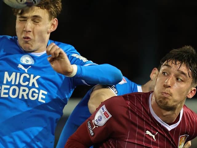 Cobblers striker Kieron Bowie battles for the ball at Peterborough on Tuesday (Picture: Pete Norton)