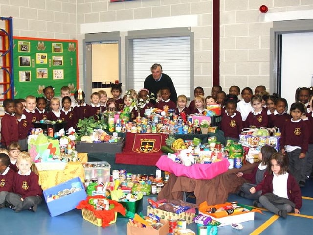 St Gregory’s Catholic Primary School welcomed John Smith from the Hope Centre as part of their annual harvest festival assembly.  Picture are reception children with the donations.