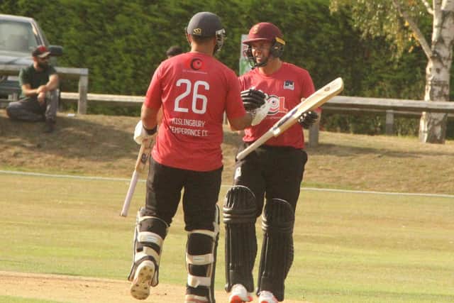 Greg Smith (right) celebrate his century for Kislingbury against Peterborough with Zaakir Khawaja (Picture: Finbarr Carroll)