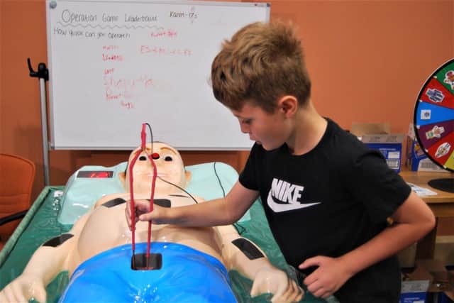 Rupert, 10, playing on a giant operation game at the community event.