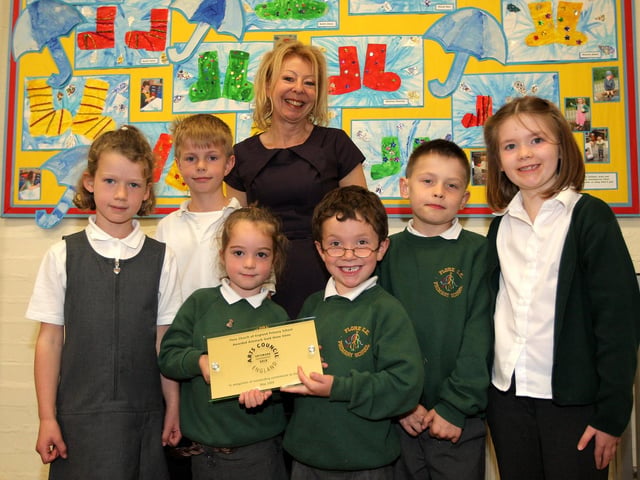 2009: Flore C.E. Primary School which has been awarded an Artsmark Gold for the 3rd time.  Pictured: Head Jan Stoppani with pupils and their plaque.