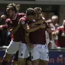 Sam Hoskins celebrates with team-mates Max Dyche and Louis Appéré after Northampton's dramatic 98th-minute equaliser against Lincoln City at Sixfields. (Photo by Pete Norton/Getty Images)