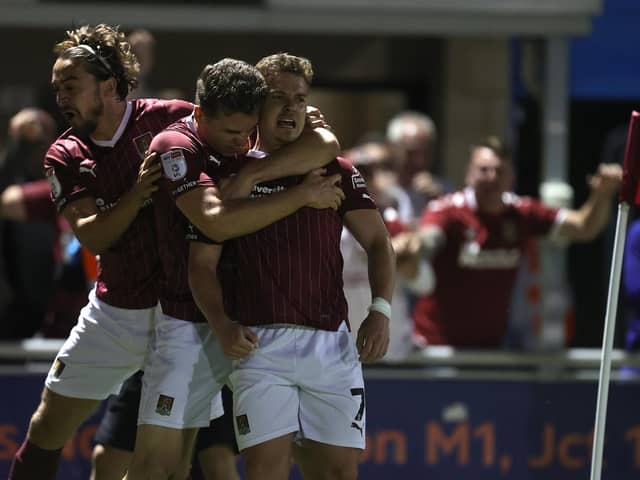 Sam Hoskins celebrates with team-mates Max Dyche and Louis Appéré after Northampton's dramatic 98th-minute equaliser against Lincoln City at Sixfields. (Photo by Pete Norton/Getty Images)