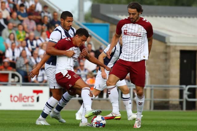 Shaun McWilliams holds off Jake Livermore. Pictures: Pete Norton.