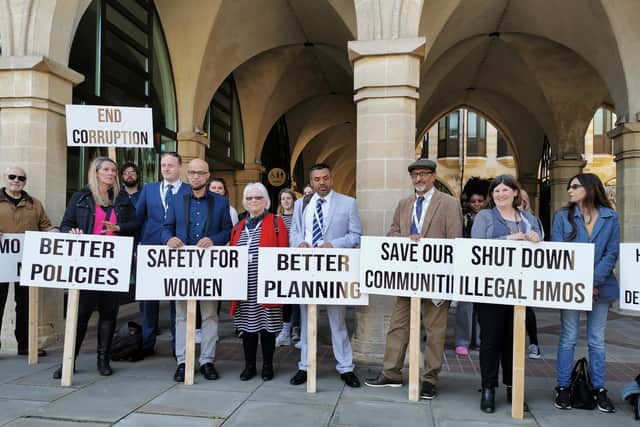 Labour councillors Danielle Stone (middle) and Enam Haque (right middle) led the protest outside the Guildhall on Thursday night just before a full council meeting