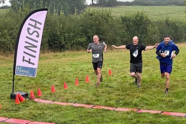 Pictured (L-R) are Kev, Richard and Brian crossing the finish line together at a previous running event