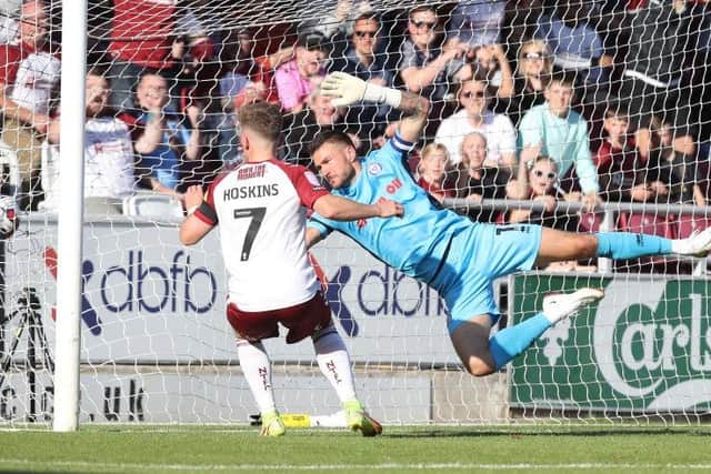 Sam Hoskins slots home his second goal against Rochdale (Picture: Pete Norton)