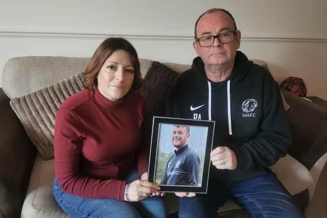 Mum Julie Needham and dad Richard Abrahams holding a picture of Luke.