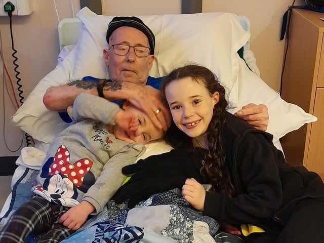 Dave Wellman pictured with his granddaughters, Cassidy and Frankie, in a hospital.