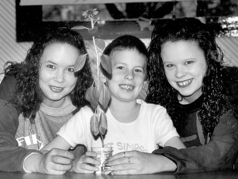 Daniel, Melissa and Maria Henson with a tiny sunflower 1991