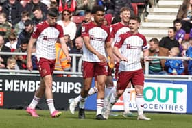 The Cobblers players celebrate after Sam Hoskins fired them into a 2-1 lead against Harrogate (Picture: Pete Norton)