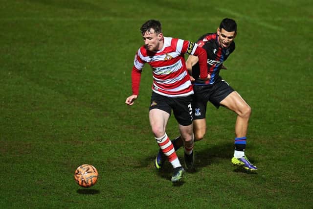 James Maxwell of Doncaster Rovers battles for the ball with Daniel Munoz of Crystal Palace during the Emirates FA Cup Fourth Round match between Doncaster Rovers and Crystal Palace at Eco-Power Stadium on February 10, 2025 in Doncaster, England. (Photo by Michael Regan/Getty Images)