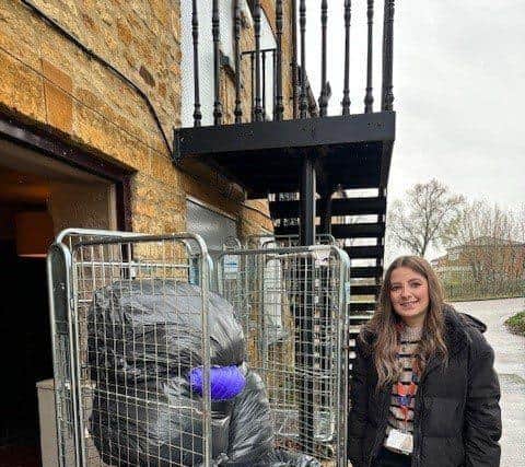 Futures colleague handing over coats at The Hope Centre, Northampton