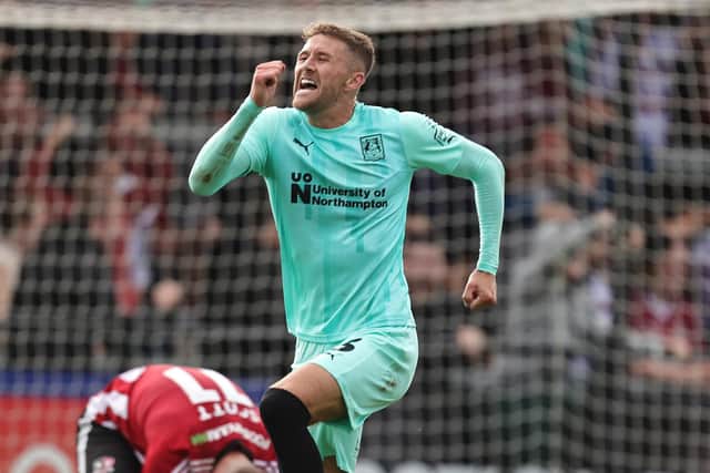 Patrick Brough jumps for joy after scoring his first Northampton goal against Exeter City.