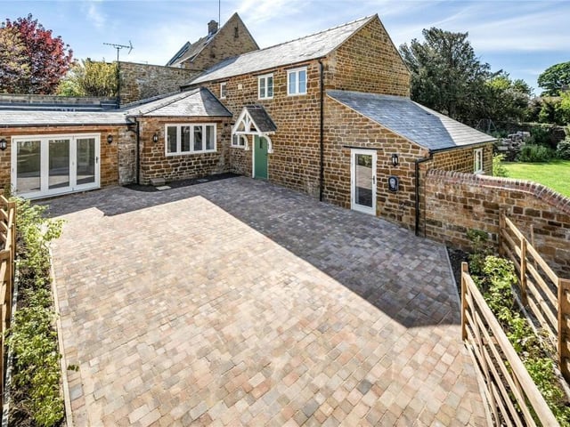 The front of the property makes an attractive first impression with a large pave driveway