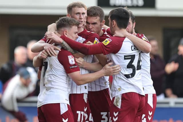 The Cobblers players celebrate Sam Hoskins' late equaliser against Newport County (Pictures: Pete Norton)