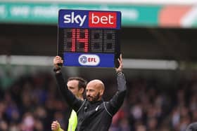 Fourth Official Darren Drysdale holds aloft the board to show 14 minutes added time in the second half  during the Sky Bet League One match between Northampton Town and Stevenage at Sixfields. (Photo by Pete Norton/Getty Images)