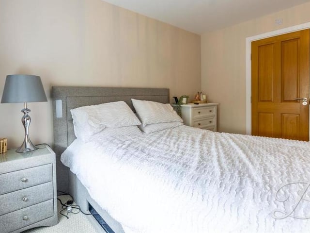 Mirrored wardrobes are a feature of the second bedroom, which also has a carpeted floor and a window facing the back of the £395,000 property.