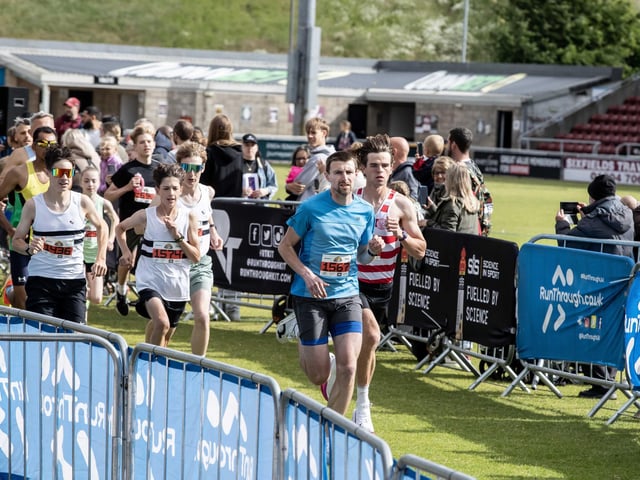 Hundreds of runners braved showers and wind to take on the race on Sunday (May 25), which started and finished at Sixfields stadium.