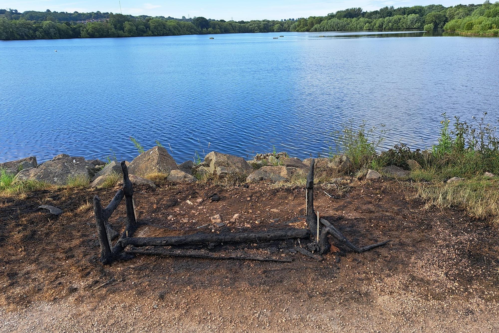 The memorial bench pictured after it was destroyed.