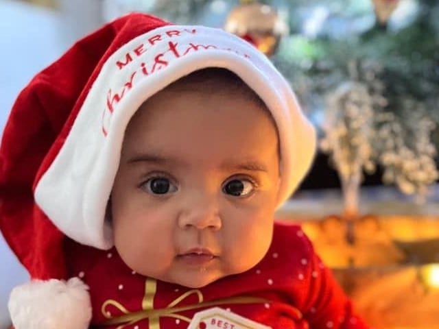 Four-month-old Sofia in a very cute Santa hat.