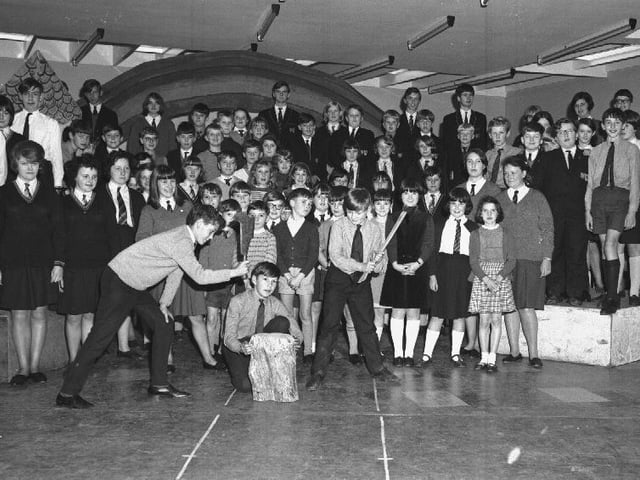 Children in school hall, two wielding axes. Clearly in the days before health and safety...