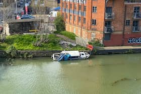 The abandoned canal boat in the River Nene near the Carlsberg brewery in Northampton has been an 'eyesore' for local residents.